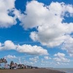 Aldeburgh beach showing buildings on Crag Path and dramatic skyscape