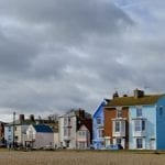 Empty shingle beach with blue sky and light wispy clouds. Aldeburgh Beach, Aldeburgh, Suffolk