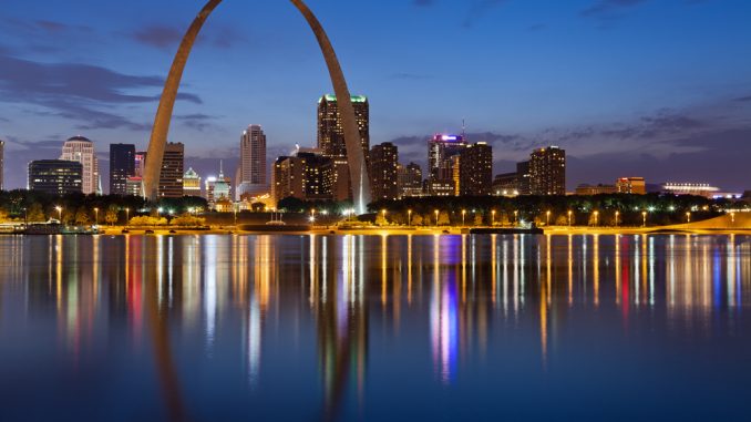 City of St. Louis skyline. Image of St. Louis downtown with Gateway Arch at twilight.