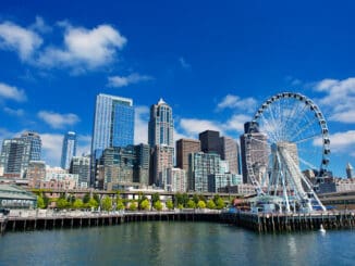 Seattle Ferris wheel, skyline and waterfront sunny day with blue sky and clouds.